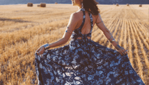 Cara Loren dress campaign hero – fashion influencer twirling paisley summer dress in wheat field
