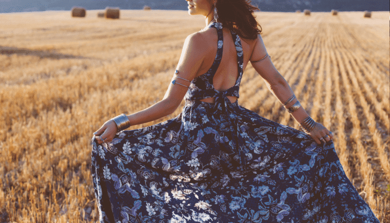 Cara Loren dress campaign hero – fashion influencer twirling paisley summer dress in wheat field