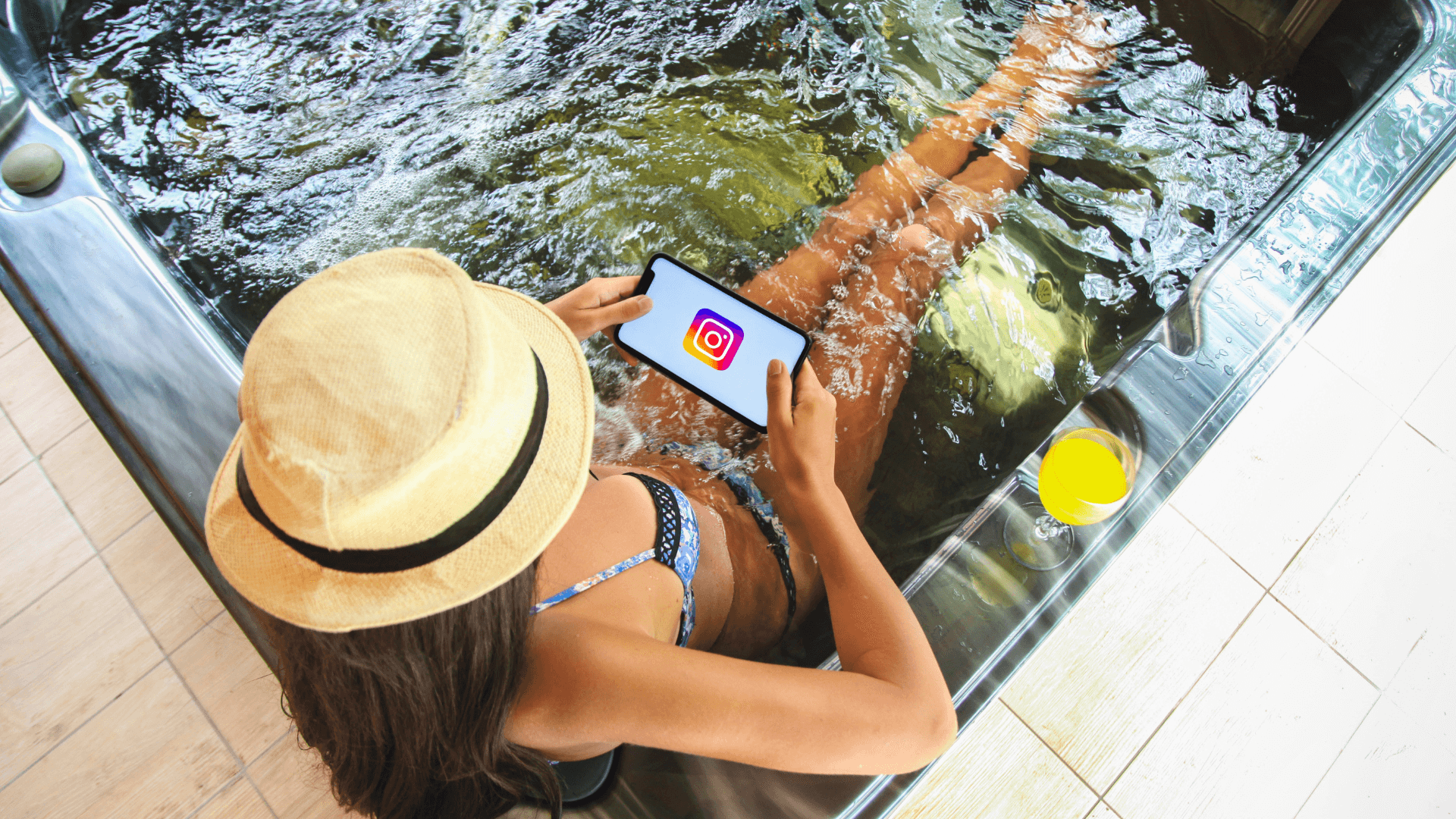 influencer lifestyle – working on tablet from luxury poolside