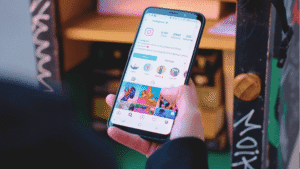 hand holding smartphone displaying an Instagram profile with story highlights