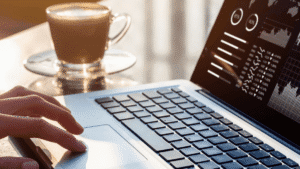 influencer research database hero – laptop with analytics dashboard and coffee