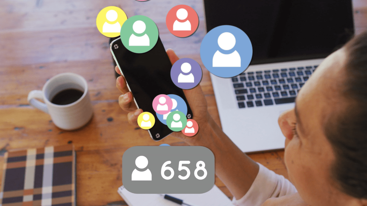 Businesswoman using smartphone with social media icons and followers count, influencer marketing concept